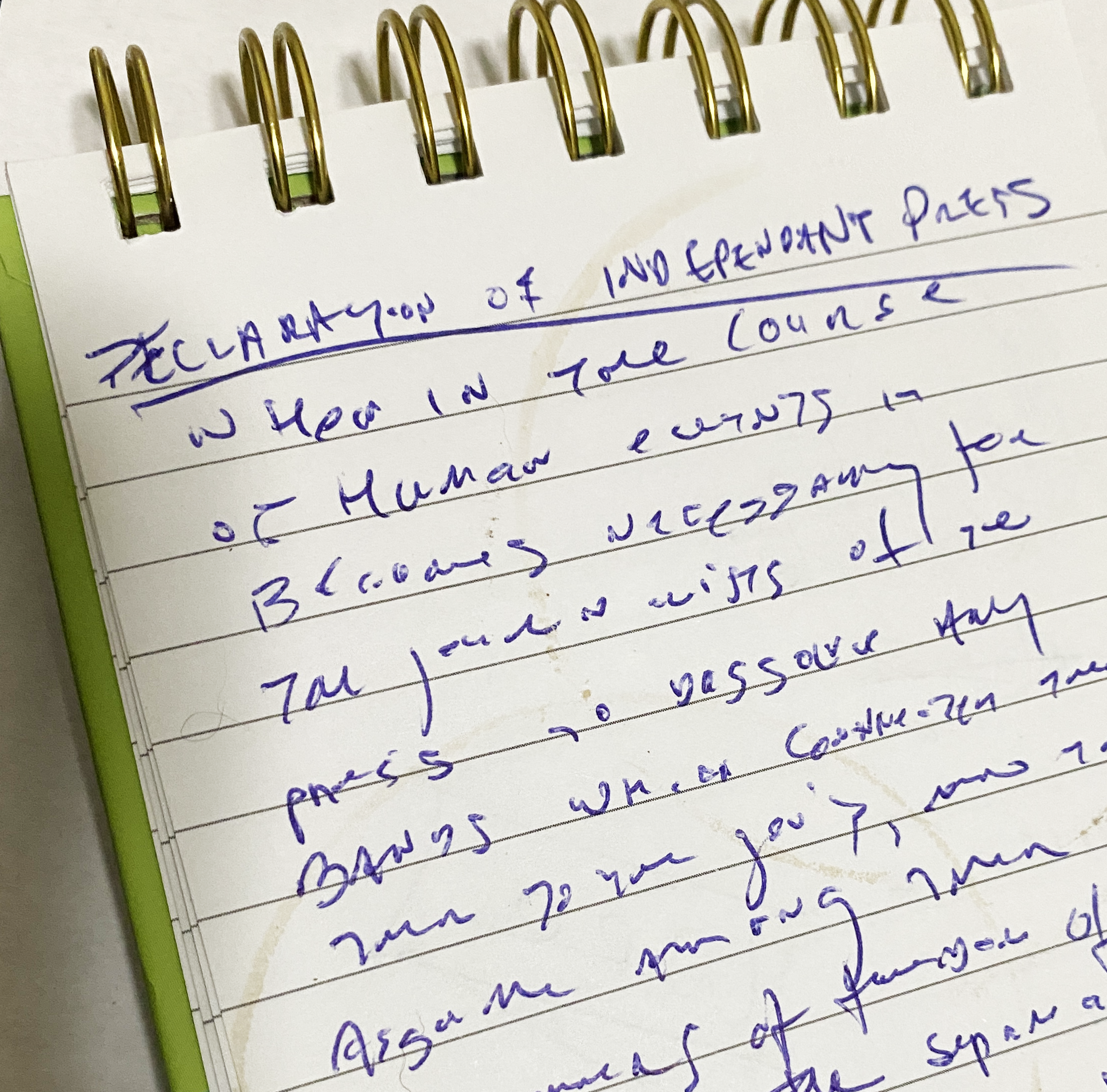 A photo of the handwritten Declaration of an independent Press in a reporter's notebook with several coffee ring stains