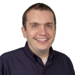 A man with short brown cropped hair smiling