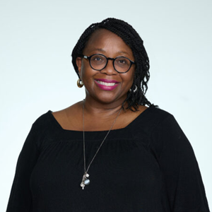 Woman with glasses and long braided hair pulled over her left shoulder