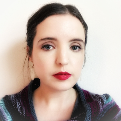 a woman with dark hair pulled back around her head and red lipstick
