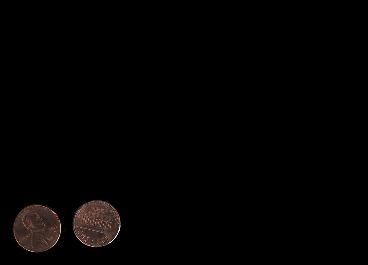 Two pennies on a dark backdrop