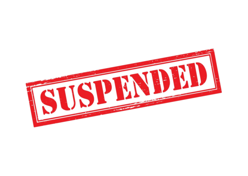the word suspended in all capital letters stamped in red on a white background